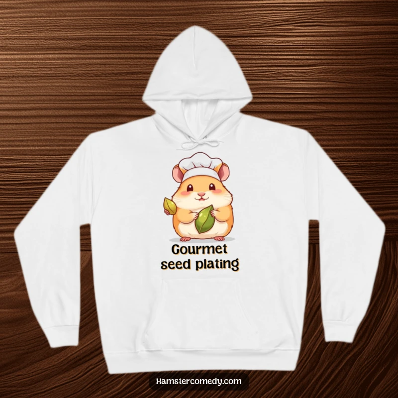 Funny hoodie with a kawaii hamster wearing a tiny chef hat, presenting a single seed with culinary expertise.