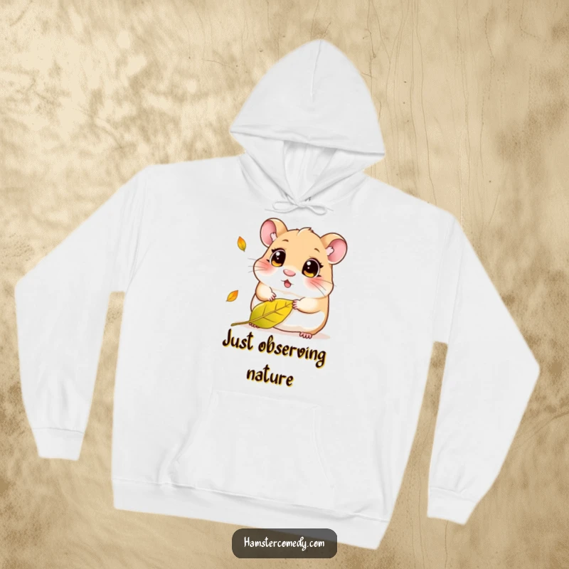 Funny Kawaii Hamster Hoodie: A cute, wide-eyed hamster intently watching a solitary leaf fall, radiating a peaceful, curious vibe.