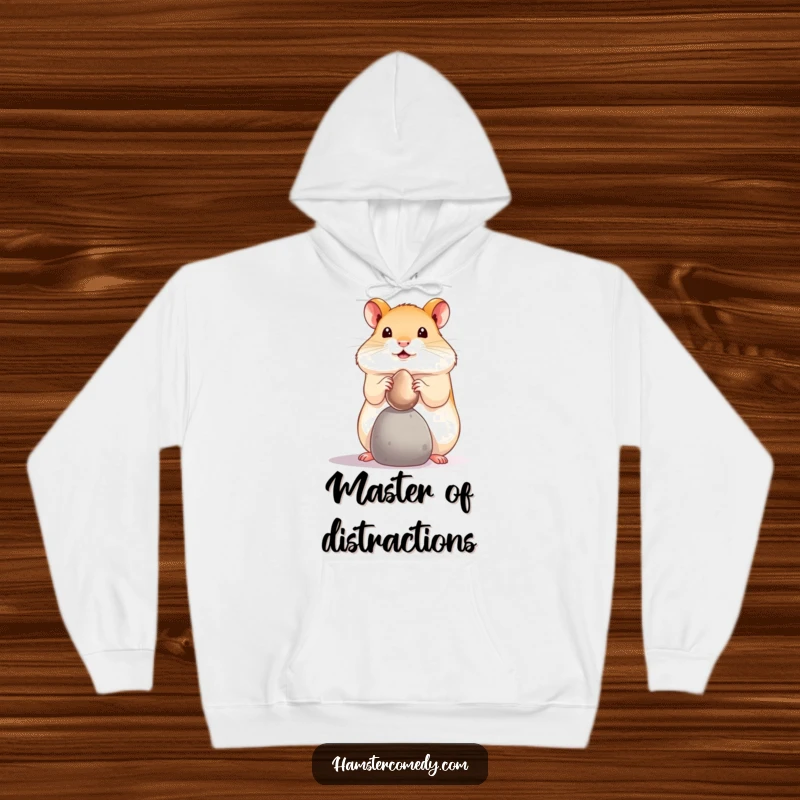 Funny hamster pebble balance hoodie, showing a tiny pet balancing a shiny pebble on its nose. Warm and humorous funny gift.