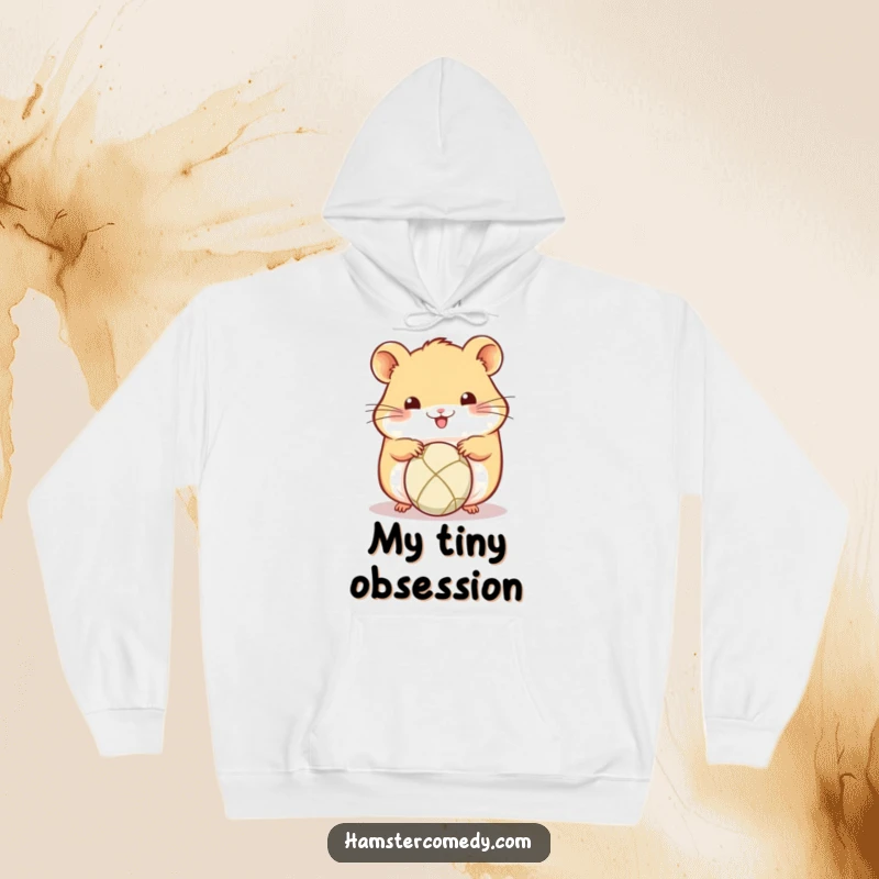 Funny Kawaii Hamster Hoodie: Cute hamster focused on rolling a tiny ball with its paws, exuding concentration and a playful spirit.